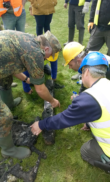 Examining recovered bomb rack